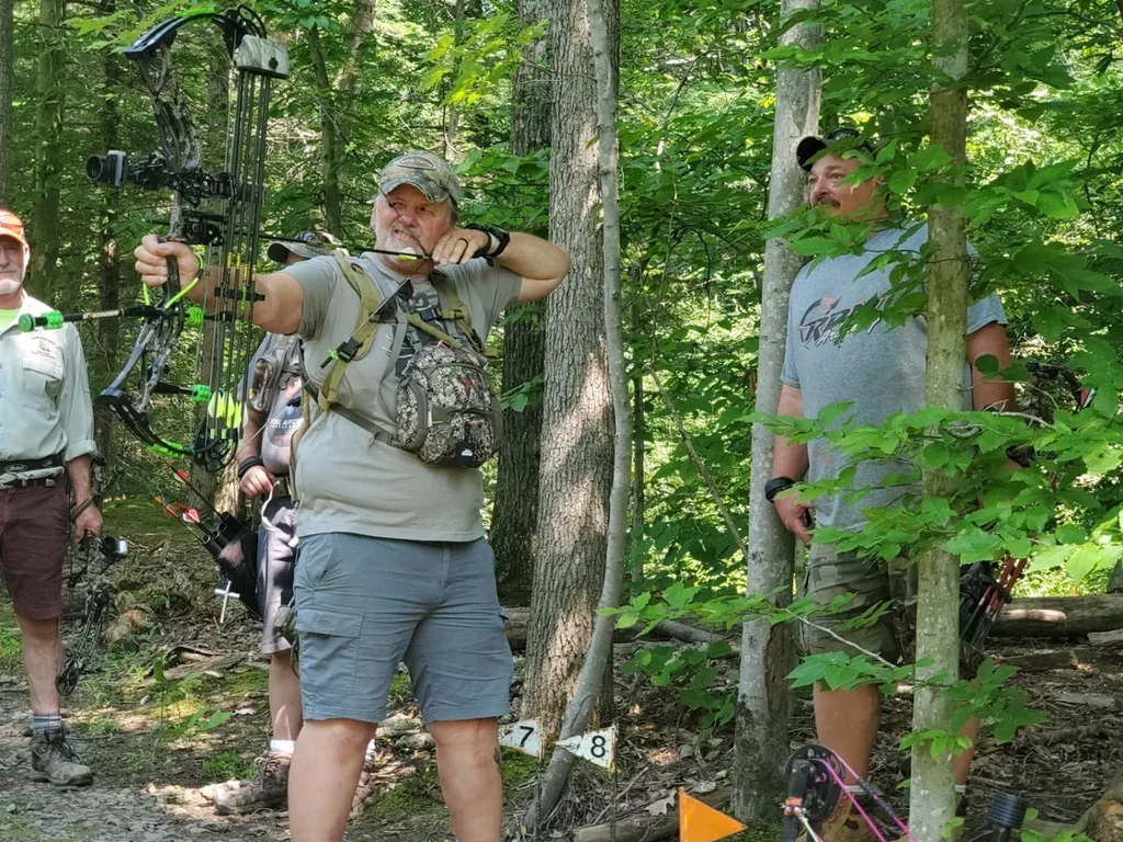 Nigel at full draw on an outdoor 3D archery course
